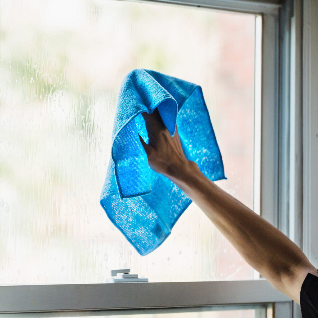 Commercial cleaner deep cleaning a window